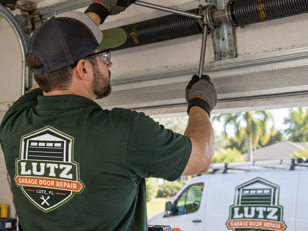 Technician checking a garage door torsion spring and center bearing plate